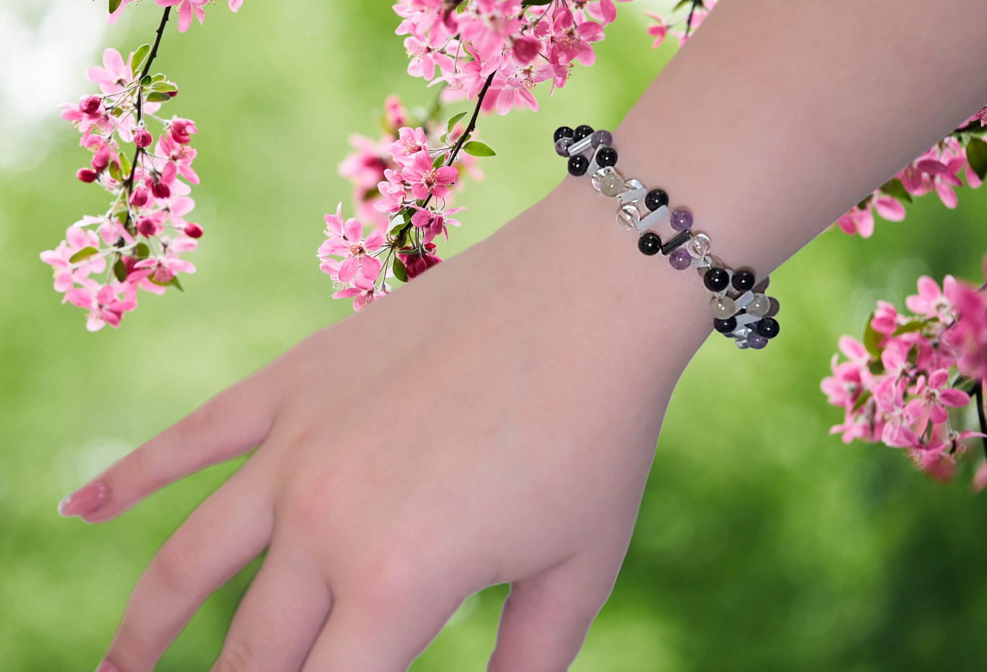 A Genoklenot® Krystal bracelet of natural stones on a wrist